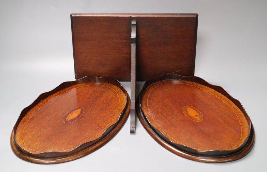 A pair of small inlaid oval mahogany trays, 31cm and a Chippendale style mahogany wall bracket, 27cm wide